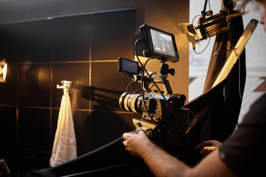 video production backstage. behind the scenes of creating video content, a professional team of cameramen with a director filming commercial ads. video content creation, video creation industry. low key, selective focus, film graine